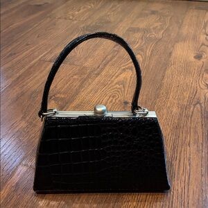 Sophisticated Black Crocodile-Embossed Mini Bag.  Small blemish and untuffting.